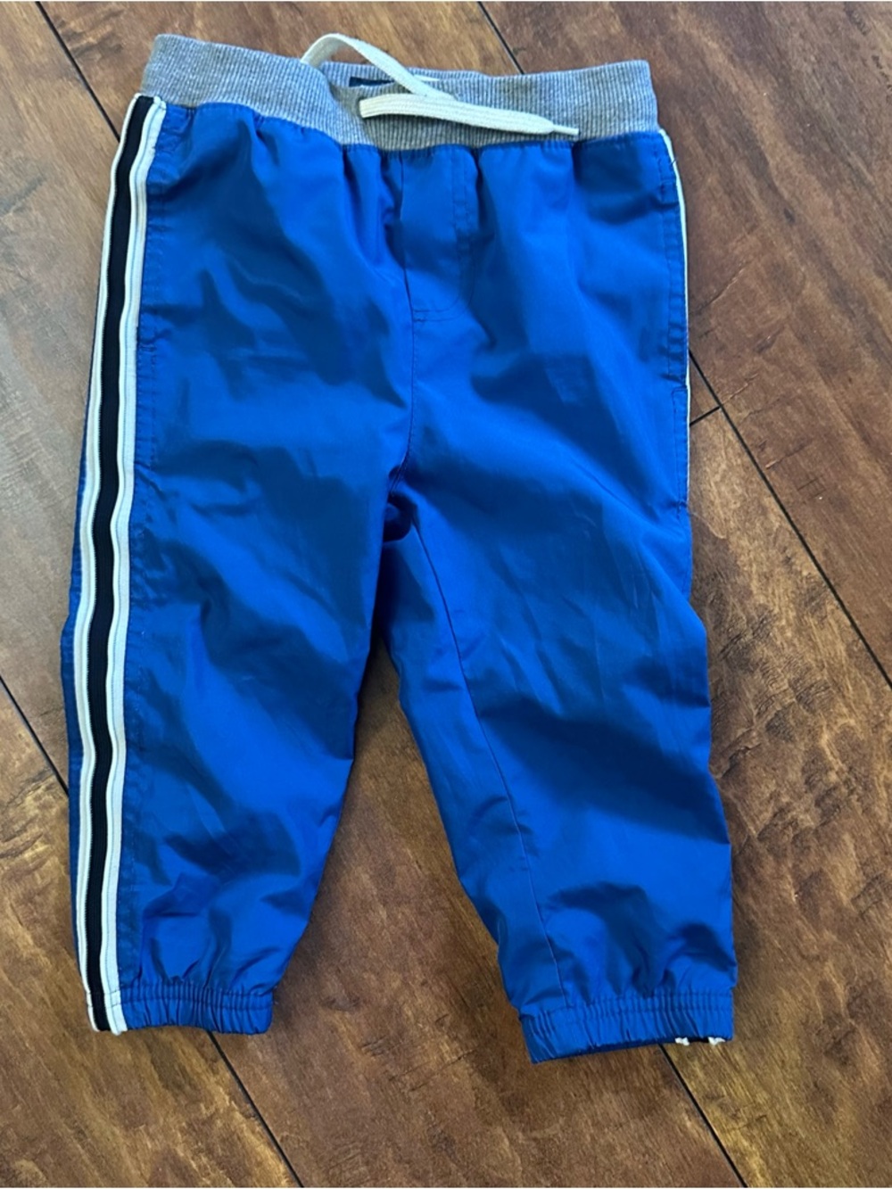 OshKosh B'gosh lined athletic pants, side stripes and drawstring waistband.